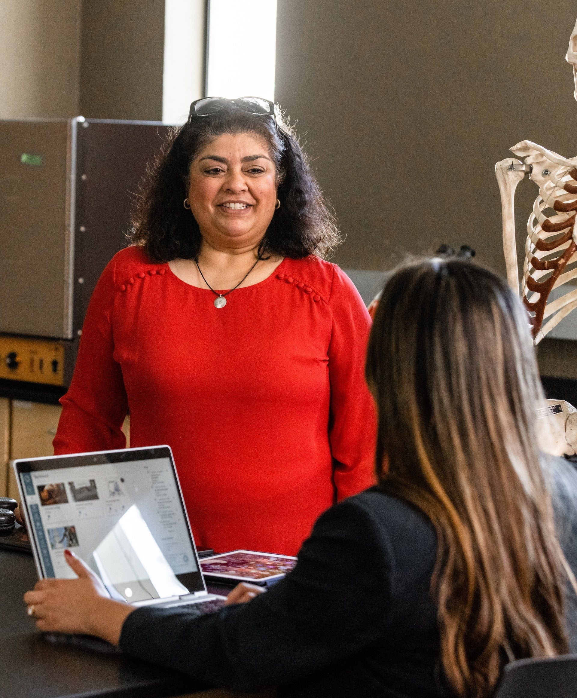 woman in red shirt in science classroom