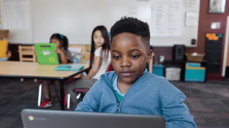 A young male student on a laptop