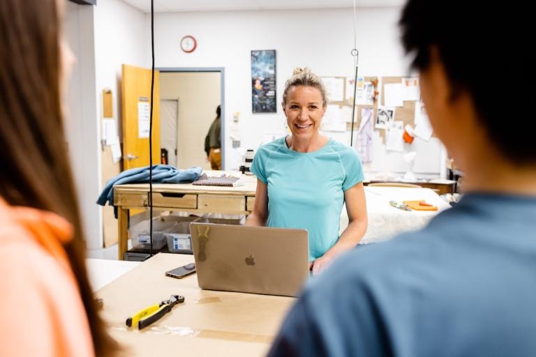 students engage with an instructor in a workshop environment