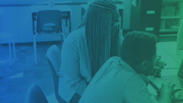 student and teacher sitting at desk with blue and green gradient overlay