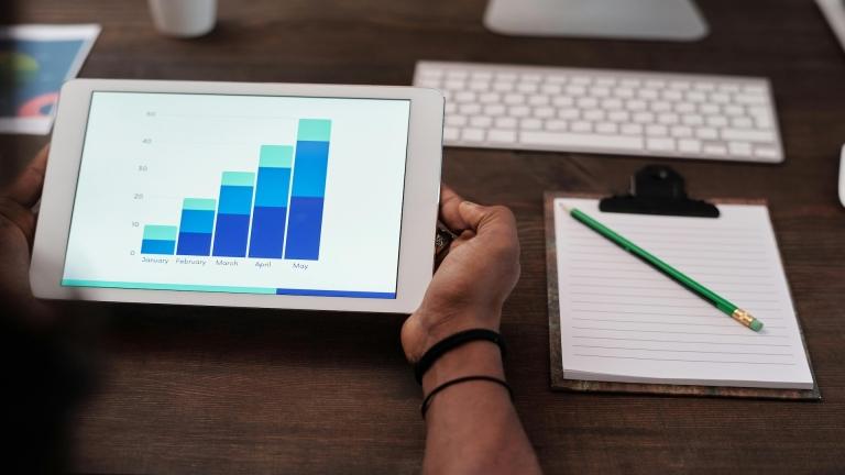 Student holds tablet with graph