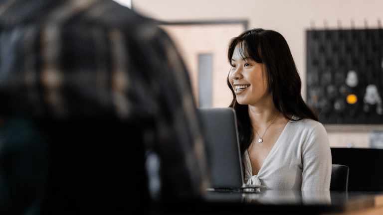 students sitting at a desk using partner apps in canvas