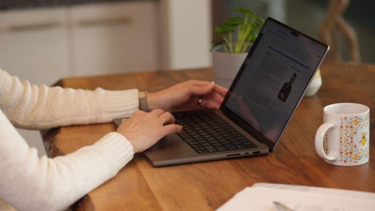 close up of women's hands on laptop keyboard