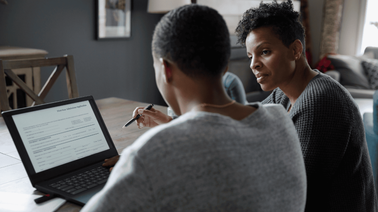two people using a laptop
